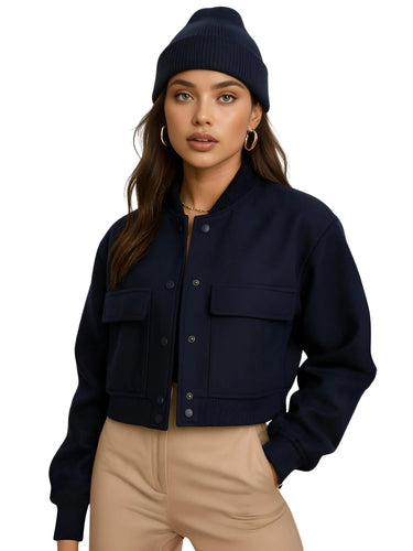 Woman wearing a navy jacket and beanie on a white background